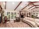 Comfortable living room showcasing a brick fireplace and French doors leading outside at 5613 E Calle Del Paisano --, Phoenix, AZ 85018