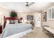 Bright main bedroom with a ceiling fan, carpet floors, and shutters on the windows at 5613 E Calle Del Paisano --, Phoenix, AZ 85018