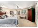 Spacious main bedroom with neutral tones, a ceiling fan, and shuttered windows at 5613 E Calle Del Paisano --, Phoenix, AZ 85018