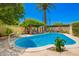 Inviting swimming pool with mature trees, complemented by a shaded seating area creating a perfect spot for relaxation at 5613 E Calle Del Paisano --, Phoenix, AZ 85018