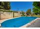 Sparkling swimming pool surrounded by well-maintained landscaping provides a relaxing and private oasis at 5613 E Calle Del Paisano --, Phoenix, AZ 85018