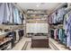 Spacious walk-in closet with custom shelving, drawers, and seating at 5613 E Calle Del Paisano --, Phoenix, AZ 85018
