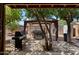 Backyard featuring a BBQ grill, a spa under a gazebo, storage units, and a paved patio at 6205 W Encinas Ln, Phoenix, AZ 85043