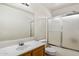Well-lit bathroom featuring a shower-tub combo with sliding doors and a single sink vanity at 6205 W Encinas Ln, Phoenix, AZ 85043