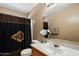 Bathroom with a vanity and mirror, featuring decorative curtains and brown walls for a warm touch at 6205 W Encinas Ln, Phoenix, AZ 85043