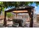 Outdoor spa featuring a hot tub under a gazebo, storage containers, and hardscape at 6205 W Encinas Ln, Phoenix, AZ 85043