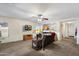 Inviting living room with a ceiling fan, plush carpeting, and an open floor plan to the kitchen at 6205 W Encinas Ln, Phoenix, AZ 85043