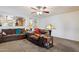 Cozy living room with an open floor plan, warm tones, and comfortable brown couches for relaxation at 6205 W Encinas Ln, Phoenix, AZ 85043
