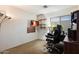 Dedicated office space featuring a computer setup, floating shelves, and neutral tones for productivity at 6205 W Encinas Ln, Phoenix, AZ 85043