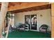 Covered patio area with outdoor seating, sliding glass door access, and green artificial turf at 6205 W Encinas Ln, Phoenix, AZ 85043