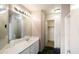 Bathroom with a large mirror, vanity, and access to the shower and walk-in closet at 6610 E University Dr # 163, Mesa, AZ 85205