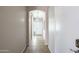 Bright hallway with tile flooring, neutral walls, and a view of the front entrance at 6610 E University Dr # 163, Mesa, AZ 85205