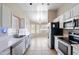 Spacious kitchen with stainless steel appliances, a double sink, and bright natural light at 6610 E University Dr # 163, Mesa, AZ 85205