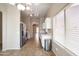Bright kitchen with stainless steel appliances, white cabinets, and tile flooring at 6610 E University Dr # 163, Mesa, AZ 85205