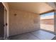 Covered patio with a concrete floor and stucco walls, providing a comfortable outdoor space at 6610 E University Dr # 163, Mesa, AZ 85205