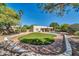 Beautiful backyard with a pool, green grass, and mature trees perfect for outdoor living and entertaining at 6615 E Phelps Rd, Scottsdale, AZ 85254