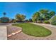 Spacious backyard features a lush green lawn and mature trees for a serene outdoor setting at 6615 E Phelps Rd, Scottsdale, AZ 85254