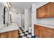Bathroom features modern fixtures, dual sinks, wooden cabinets, a toilet, and glass-enclosed shower at 6615 E Phelps Rd, Scottsdale, AZ 85254