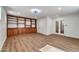 Spacious bonus room featuring built-in shelving and cabinet space with sleek laminate wood flooring at 6615 E Phelps Rd, Scottsdale, AZ 85254