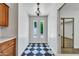 Bright hallway with black and white flooring, decorative lighting, and access to other rooms at 6615 E Phelps Rd, Scottsdale, AZ 85254