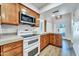 Well-lit kitchen features wood cabinets, stone countertops, and stainless steel microwave at 6615 E Phelps Rd, Scottsdale, AZ 85254