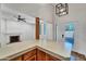 Modern kitchen with stylish countertops, wooden cabinets, and a view into the bright living room at 6615 E Phelps Rd, Scottsdale, AZ 85254