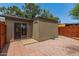 Backyard featuring a sliding glass door, small storage room, patio and rock landscaping at 6711 W Osborn Rd # 82, Phoenix, AZ 85033