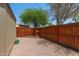 Backyard featuring a wood fence, rock landscaping, shade trees and a view of neighboring properties at 6711 W Osborn Rd # 82, Phoenix, AZ 85033