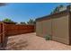 Backyard featuring a wood fence, rock landscaping, shade trees and the property's exterior wall at 6711 W Osborn Rd # 82, Phoenix, AZ 85033