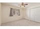 Neutral bedroom features a ceiling fan, carpet flooring, window and closet with doors at 6711 W Osborn Rd # 82, Phoenix, AZ 85033