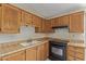 Bright kitchen features tile flooring, wood cabinets, and black range at 6711 W Osborn Rd # 82, Phoenix, AZ 85033