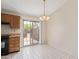 Bright kitchen features tile flooring, wood cabinets, black range, and sliding glass doors at 6711 W Osborn Rd # 82, Phoenix, AZ 85033