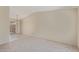 Neutral living space with light tile and carpet flooring leading to sliding door at 6711 W Osborn Rd # 82, Phoenix, AZ 85033