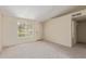 Cozy living room with neutral carpet, white walls, a window, and access to a hallway at 6711 W Osborn Rd # 82, Phoenix, AZ 85033