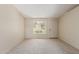 Bright living room with neutral carpet, white walls, and natural light from the large window at 6711 W Osborn Rd # 82, Phoenix, AZ 85033
