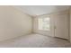 Welcoming living room with neutral carpet, white walls, and natural light from the window at 6711 W Osborn Rd # 82, Phoenix, AZ 85033