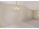 Neutral living space with a decorative light fixture, light tile and carpet flooring at 6711 W Osborn Rd # 82, Phoenix, AZ 85033