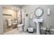 Well-lit bathroom featuring a pedestal sink, and tiled walk-in shower with accessibility features at 6722 E Jean Dr, Scottsdale, AZ 85254