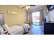 Cozy bedroom features a ceiling fan, wood floors, and sliding glass doors to a balcony at 6722 E Jean Dr, Scottsdale, AZ 85254