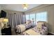 Cozy bedroom with two twin beds, soft lighting, and a decorative window at 6722 E Jean Dr, Scottsdale, AZ 85254