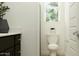 Bright powder room with a dark vanity, white countertop, window, and simple decor at 7848 W Tether Trl, Peoria, AZ 85383