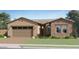 Charming single-story home with a well-maintained lawn and a two-car garage at 7848 W Tether Trl, Peoria, AZ 85383