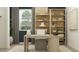 Cozy office space with stylish shelving, natural light, a modern desk, and a comfortable chair at 7848 W Tether Trl, Peoria, AZ 85383