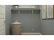 Functional laundry room with ample shelving for organized storage and convenience at 7848 W Tether Trl, Peoria, AZ 85383