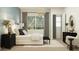 Inviting main bedroom with blue accent wall, white bed, dark wood furniture and cozy decor at 7848 W Tether Trl, Peoria, AZ 85383