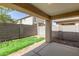 View of covered patio and privacy wall in the backyard with grass and gravel at 857 E Impreria St, San Tan Valley, AZ 85140