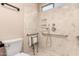 Bathroom featuring a tiled shower with grab bars and adjustable shower head at 857 E Impreria St, San Tan Valley, AZ 85140