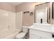 Modern bathroom featuring a vessel sink, tiled shower and neutral walls at 857 E Impreria St, San Tan Valley, AZ 85140