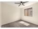 This bedroom has neutral carpet and a ceiling fan at 857 E Impreria St, San Tan Valley, AZ 85140