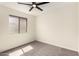 Bright bedroom with window and carpet flooring with a modern ceiling fan at 857 E Impreria St, San Tan Valley, AZ 85140